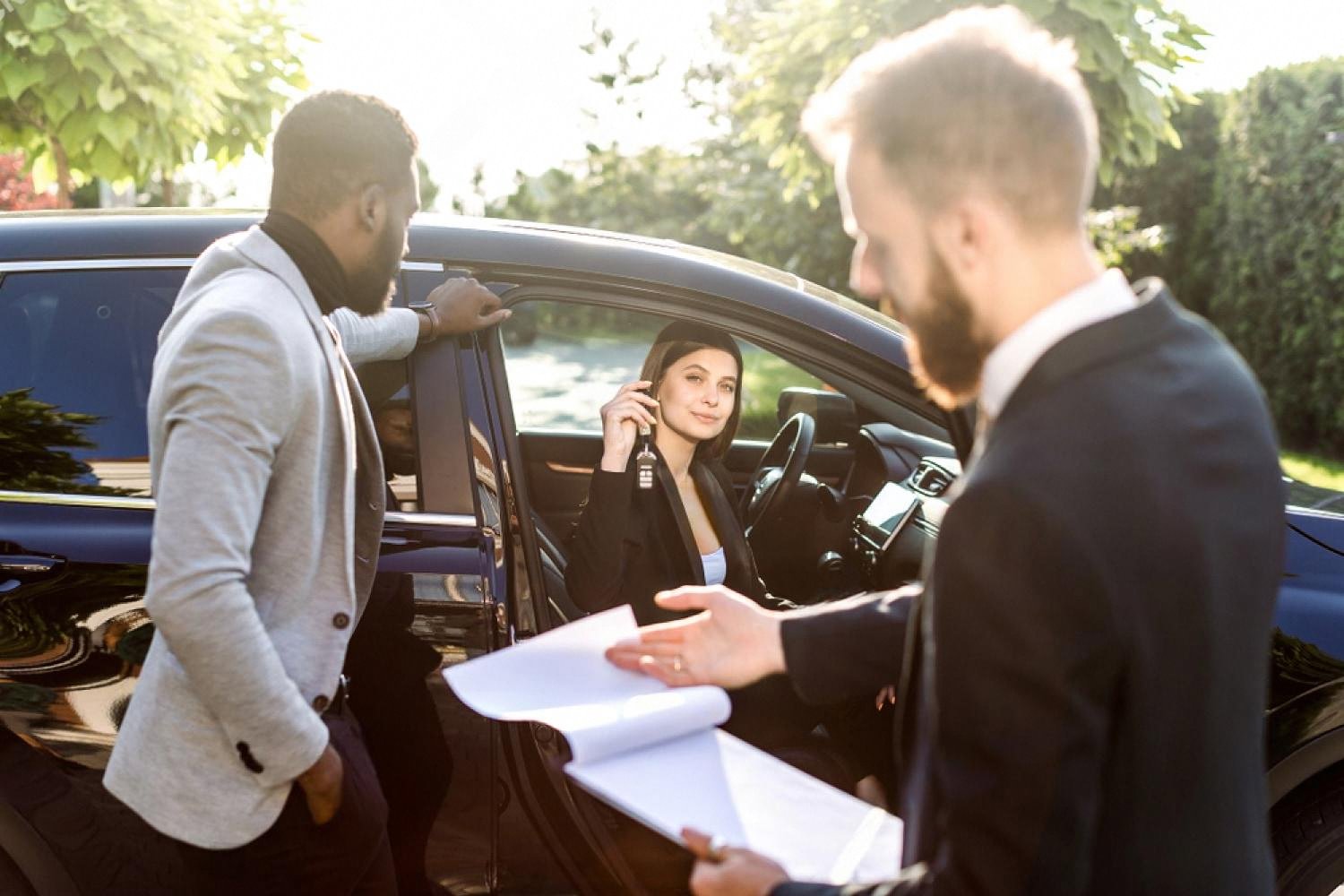 Tourist collecting keys to a rented crossover from a rental agent in Australia